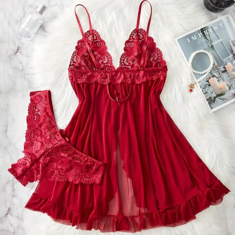 Red lace nightgown set back on a white surface with a magazine