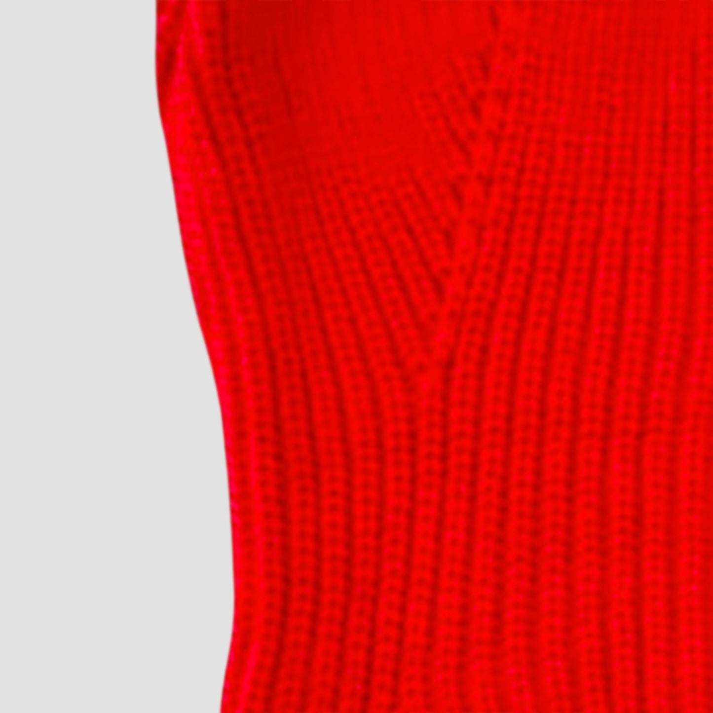 Close-up of a red textured fabric on a light gray background