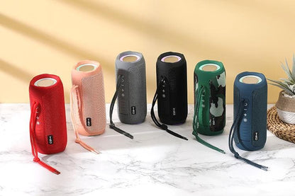 A collection of T&G Portable Bluetooth Speakers in various colors including red, black, gray, pink, blue, and green, each featuring a compact cylindrical design with a strap.