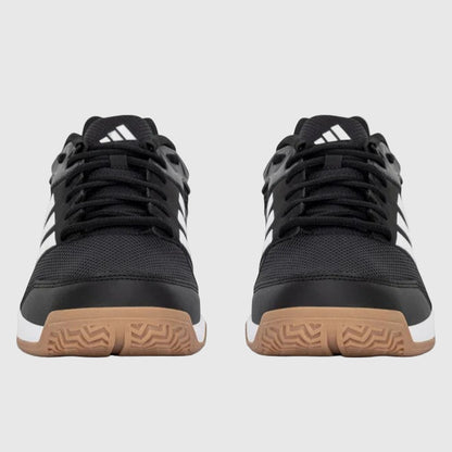 Black Adidas shoes with white stripes on a grey background