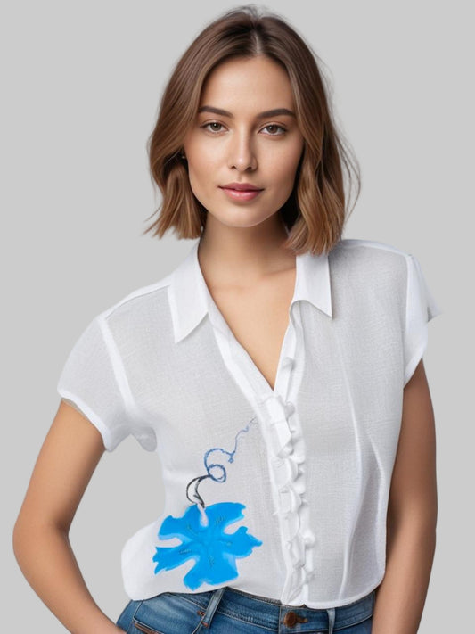 Woman wearing a white blouse with a blue floral design
